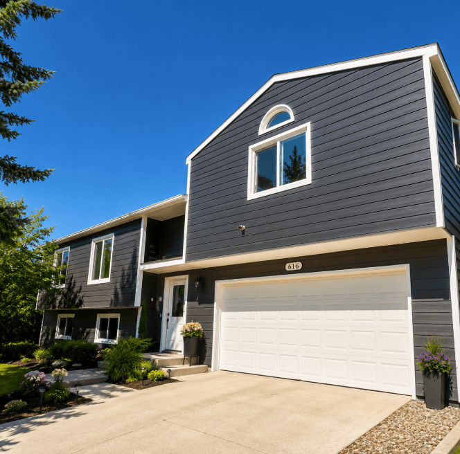 Two-story home clad in charcoal-gray WeatherMax Extreme Siding with crisp white trim