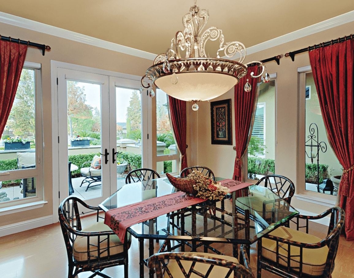 White full-lite French doors opening from a dining room onto a patio